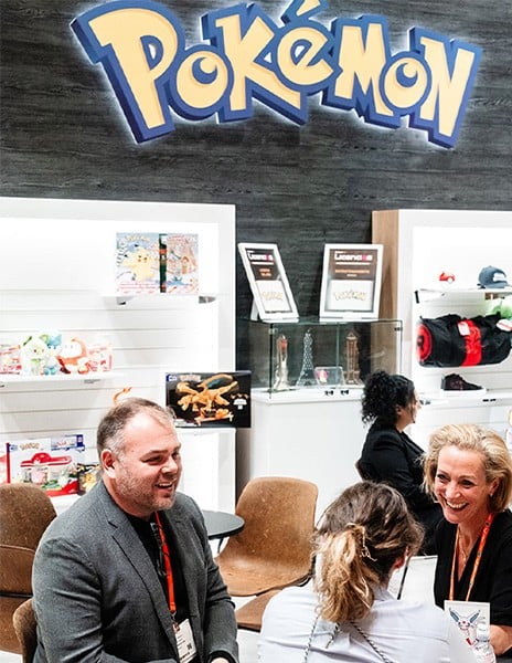 Pokemon logo showing at booth while professionals network